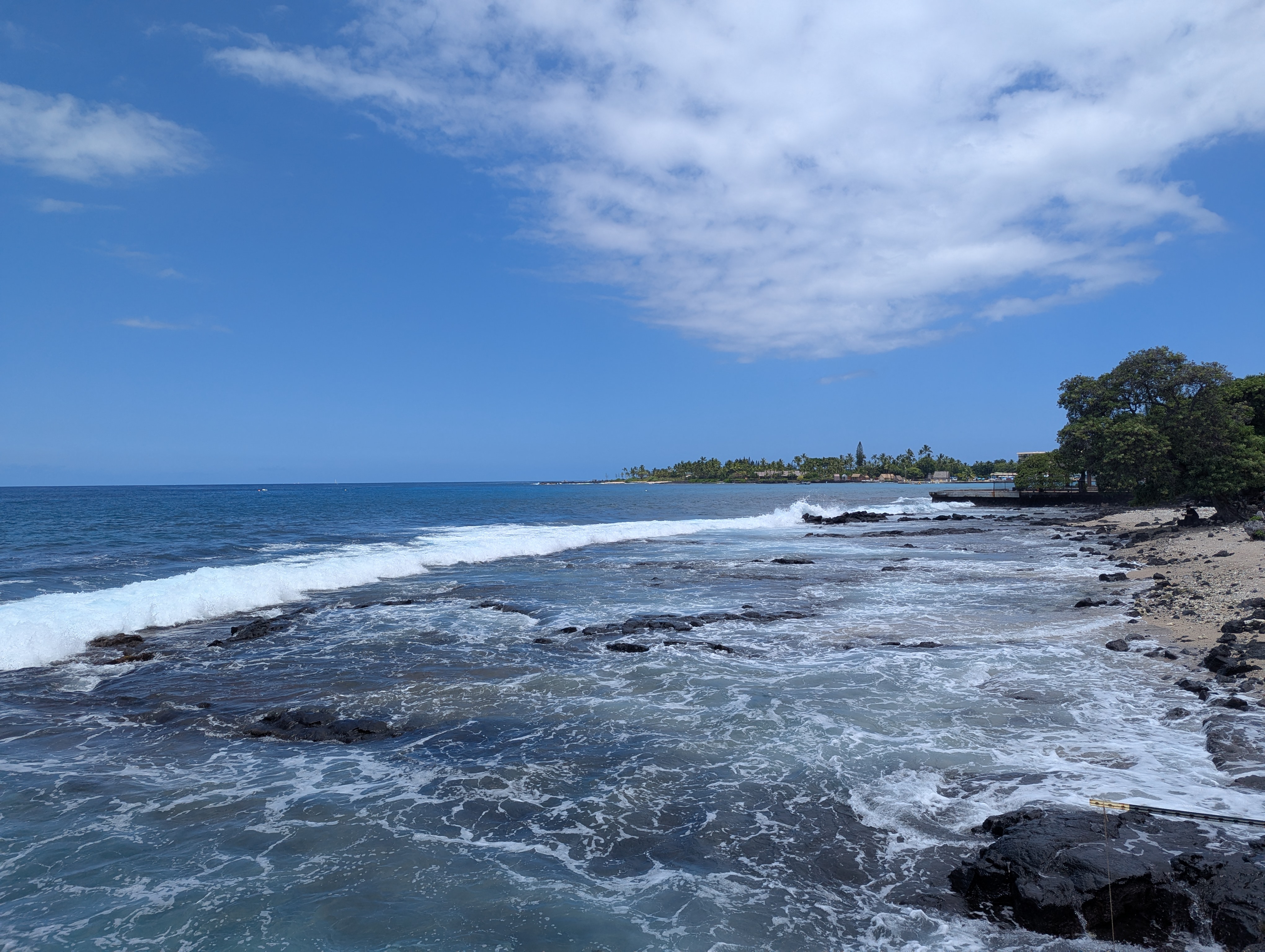 Ocean shoreline with waves and a rocky coast