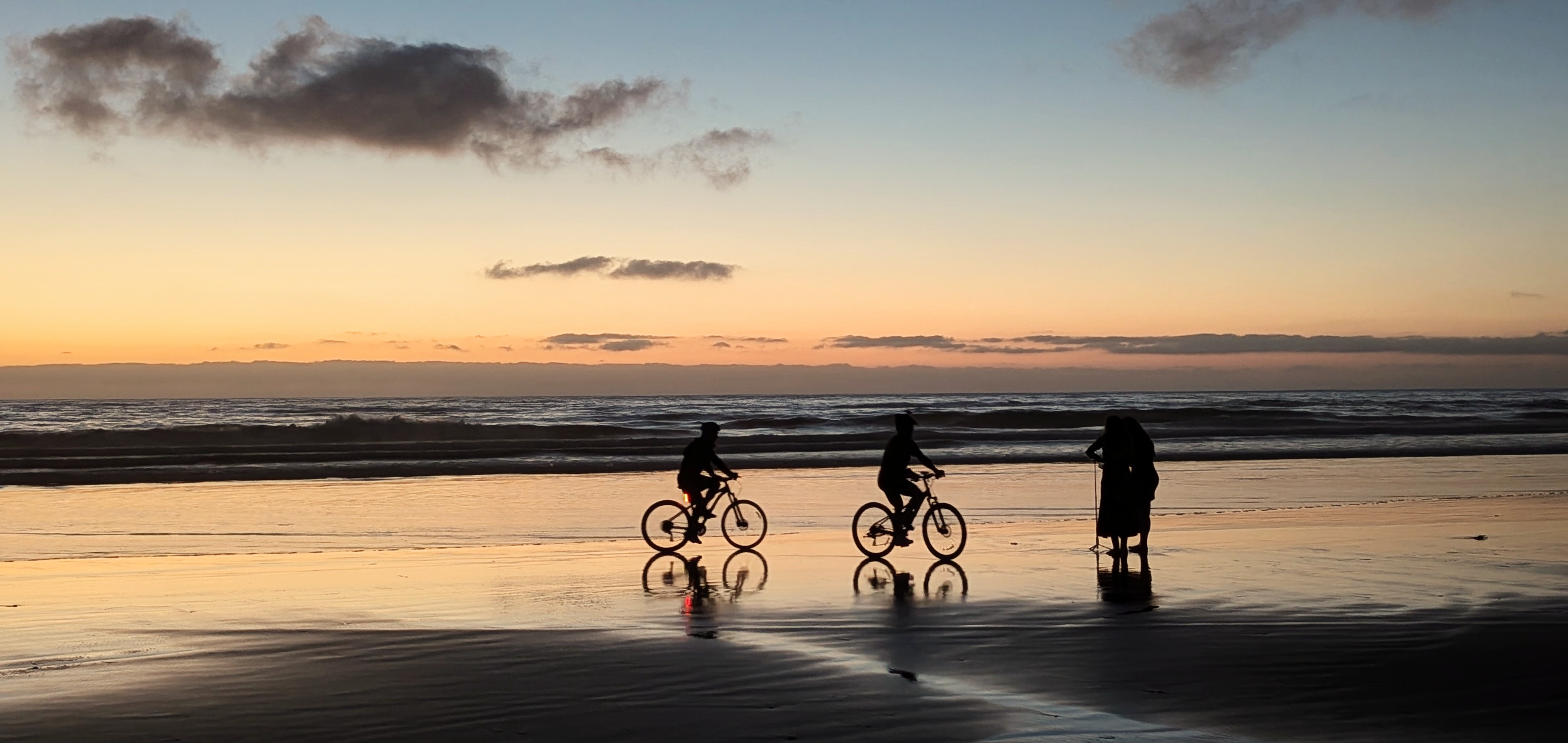 Bicycles on a beach at sunset